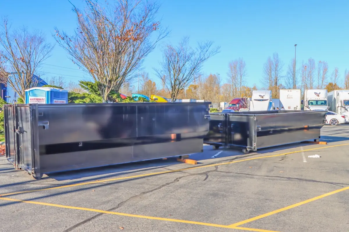 Professional dumpster rental service with roll-off container on residential driveway in Jessup